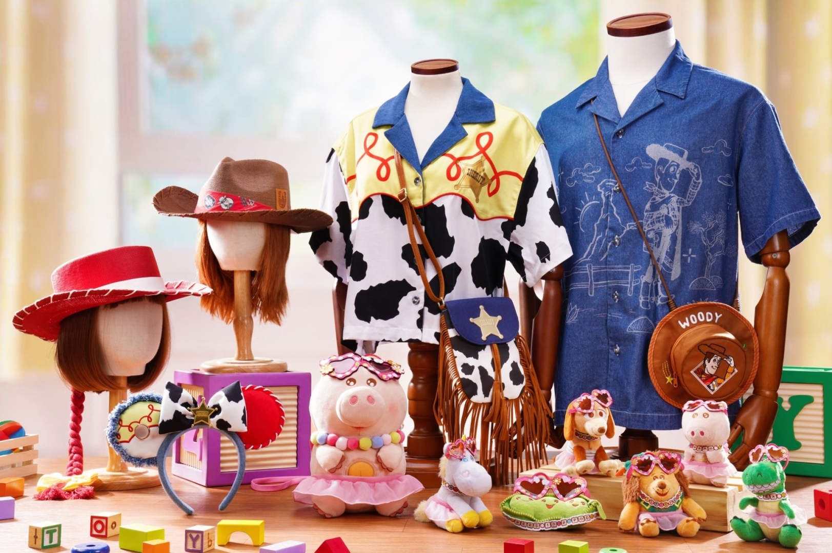 The image showcases a display of children's toys and clothing inspired by a popular animated franchise. Various outfits, hats, and plush toys are arranged on mannequins and a table, highlighting playful themes.
