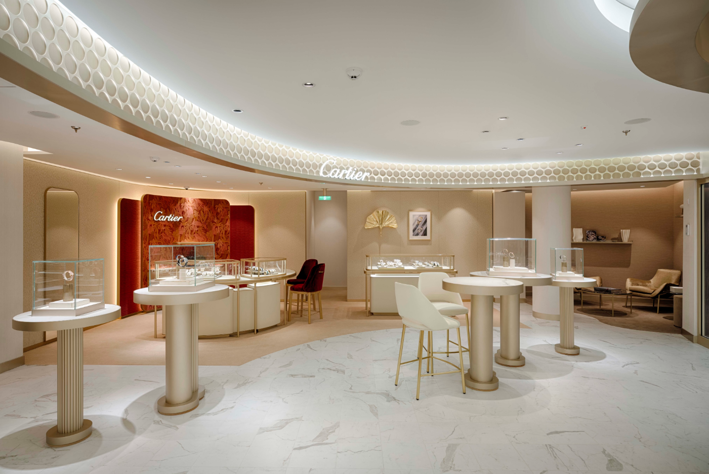 The image depicts the interior of a luxurious Cartier jewelry boutique, showcasing elegant display cases and sophisticated design elements. Soft lighting enhances the opulent atmosphere, making it an inviting shopping environment.