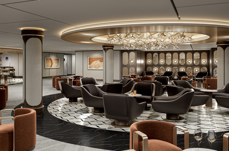 The image showcases a luxurious lounge area featuring elegant seating and sophisticated decor. The design elements include a circular chandelier and intricate flooring patterns, creating a refined atmosphere.