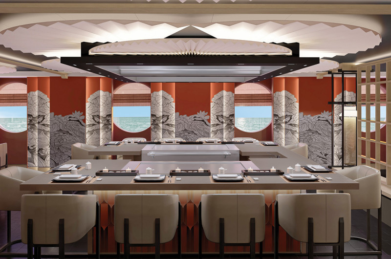 The image depicts the interior of an upscale restaurant featuring modern decor and elegant seating. Large windows provide a view of the ocean, while decorative elements such as stylized wall art and ambient lighting enhance the atmosphere.