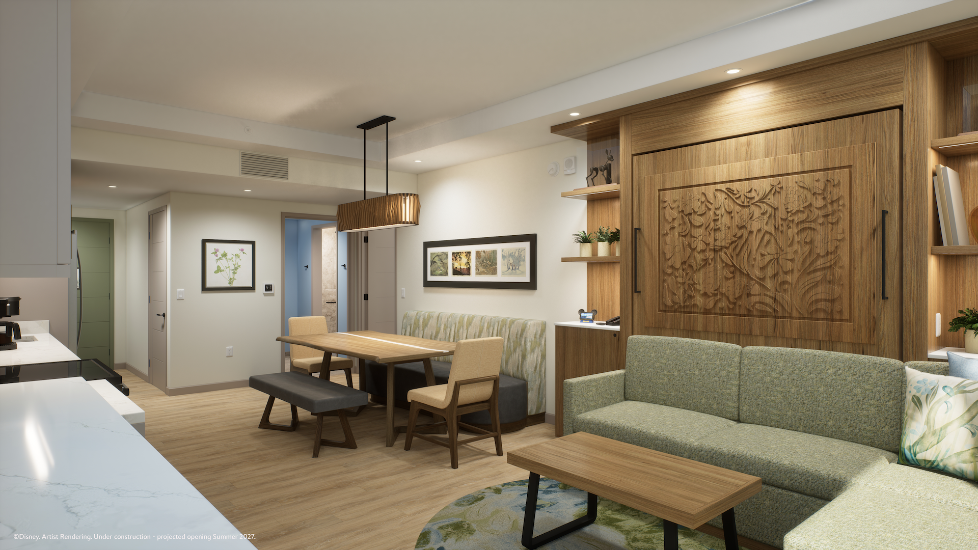 The image showcases a modern lodge guest room featuring a stylish living area with a couch, dining table, and customized wooden accents. The room is thoughtfully designed with natural light and contemporary furnishings.
