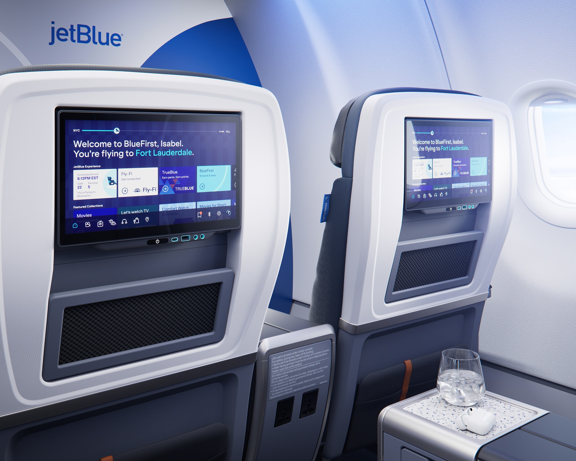 The image shows the interior cabin of a JetBlue aircraft, featuring two passenger seats with individual screen displays. The screens display a welcome message and various entertainment options, emphasizing the BlueFirst service.