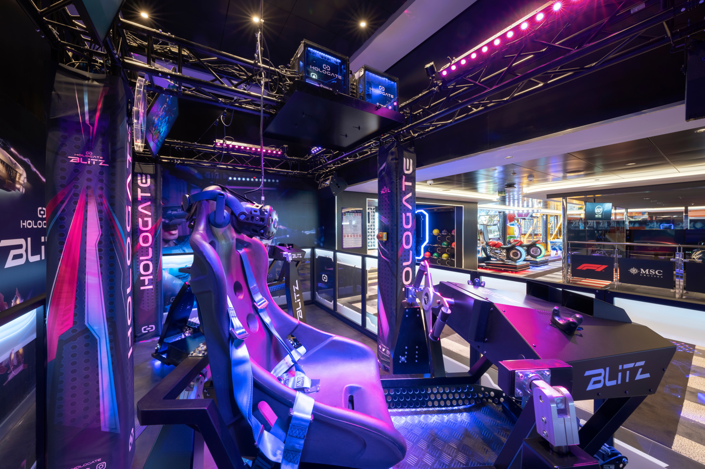 The image showcases a high-tech virtual reality gaming setup featuring a racing simulator. The environment is illuminated with colorful LED lights, providing a modern and engaging atmosphere for players.