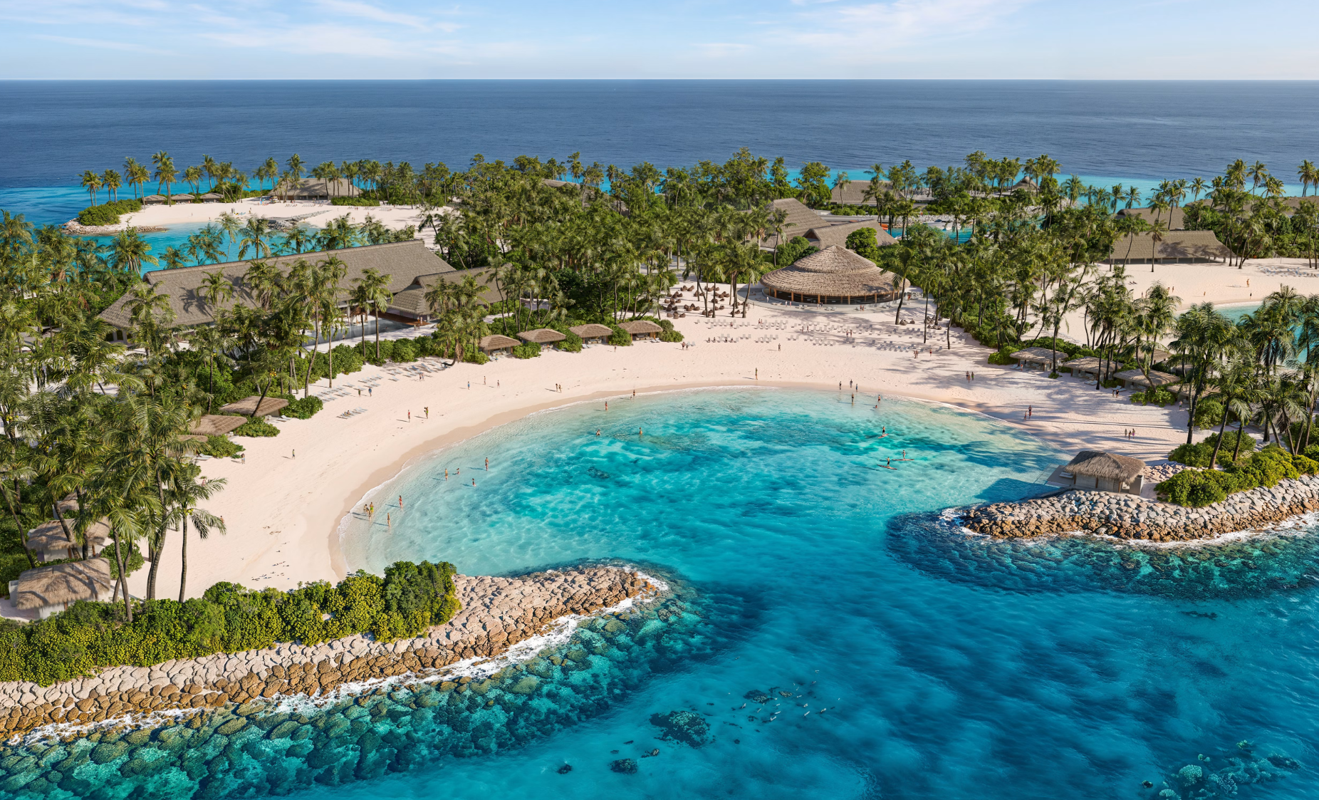 Aerial view of a tropical beach resort featuring white sand, palm trees, and clear turquoise water. The setting showcases several thatched-roof structures and lounging areas for guests.
