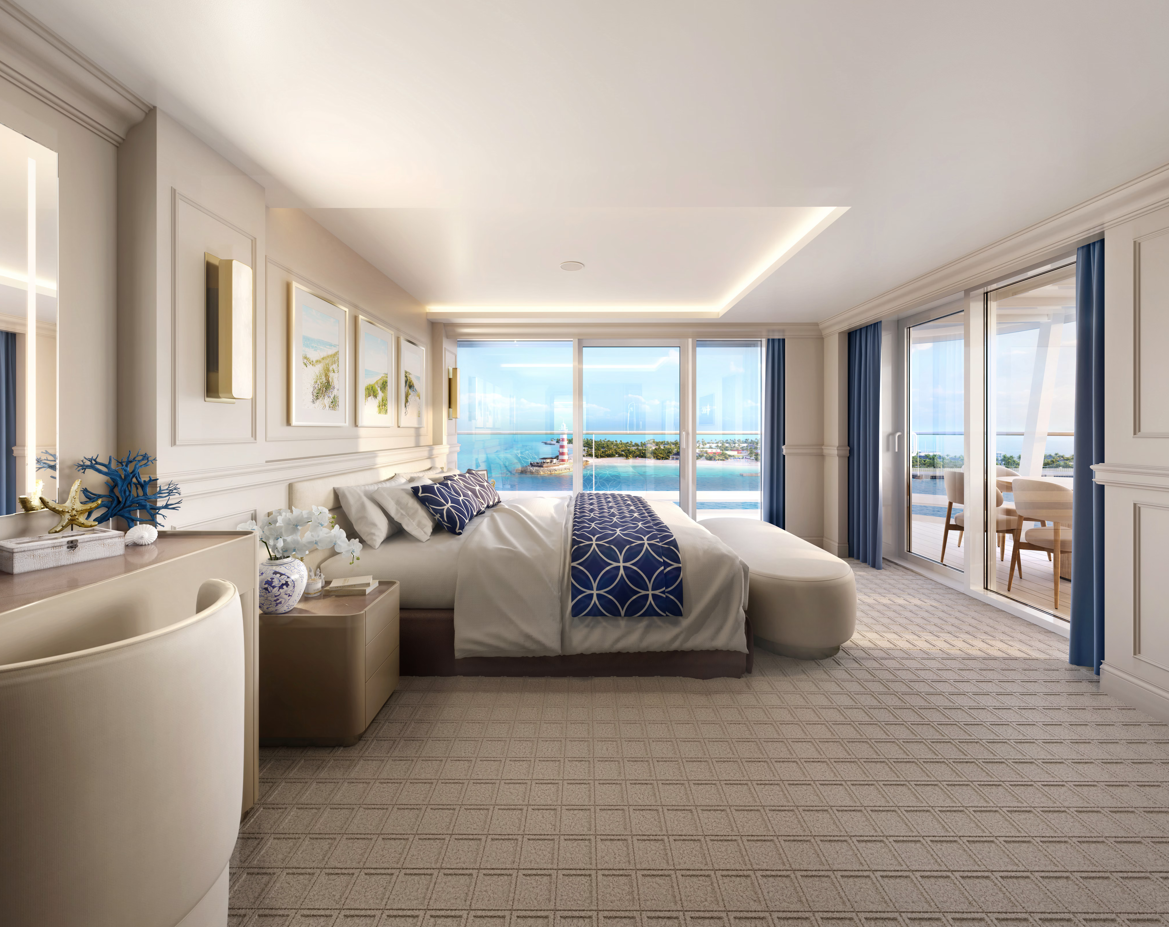 The image shows a luxurious hotel room featuring modern decor and expansive windows overlooking a scenic view. The room is designed with neutral colors, elegant furnishings, and a spacious layout, suggesting a high-end hospitality experience.
